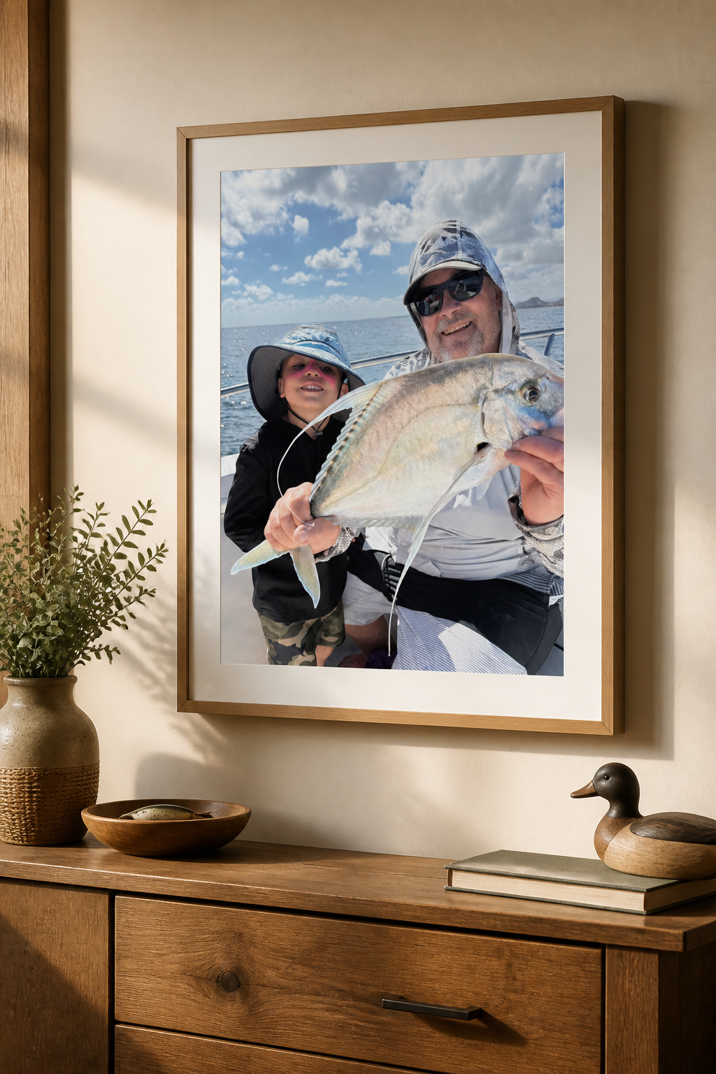 The same fishing photo displayed as a framed TrophyPic on a wall